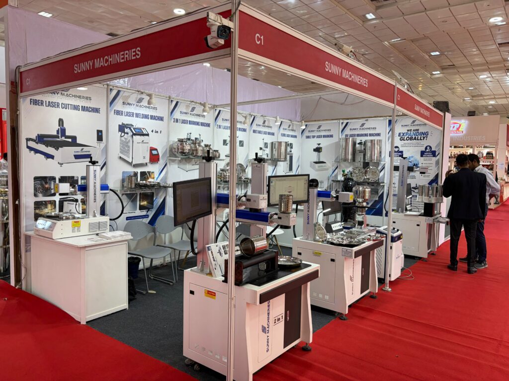 Sunny Machineries exhibition booth at Indian Houseware Show 2026 featuring fiber laser marking, laser engraving, fiber laser welding, and fiber laser cutting machines for the houseware industry.